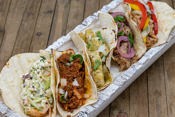Five authentic tacos near Barclay-Kingston, Cherry Hill, New Jersey on a serving tray.