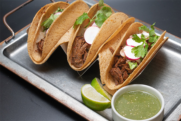 Three Carnitas Tacos on a tray, some of our street tacos near Pennsauken, NJ.